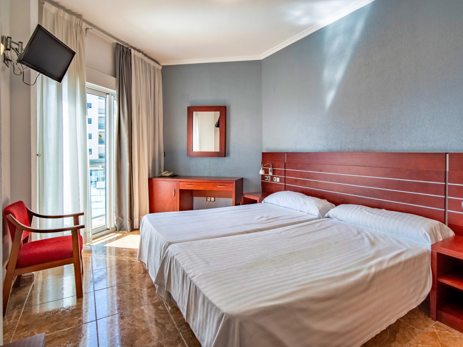 The building Hotel La Familia Gallo Rojo, located in El Campello, next to the beach.